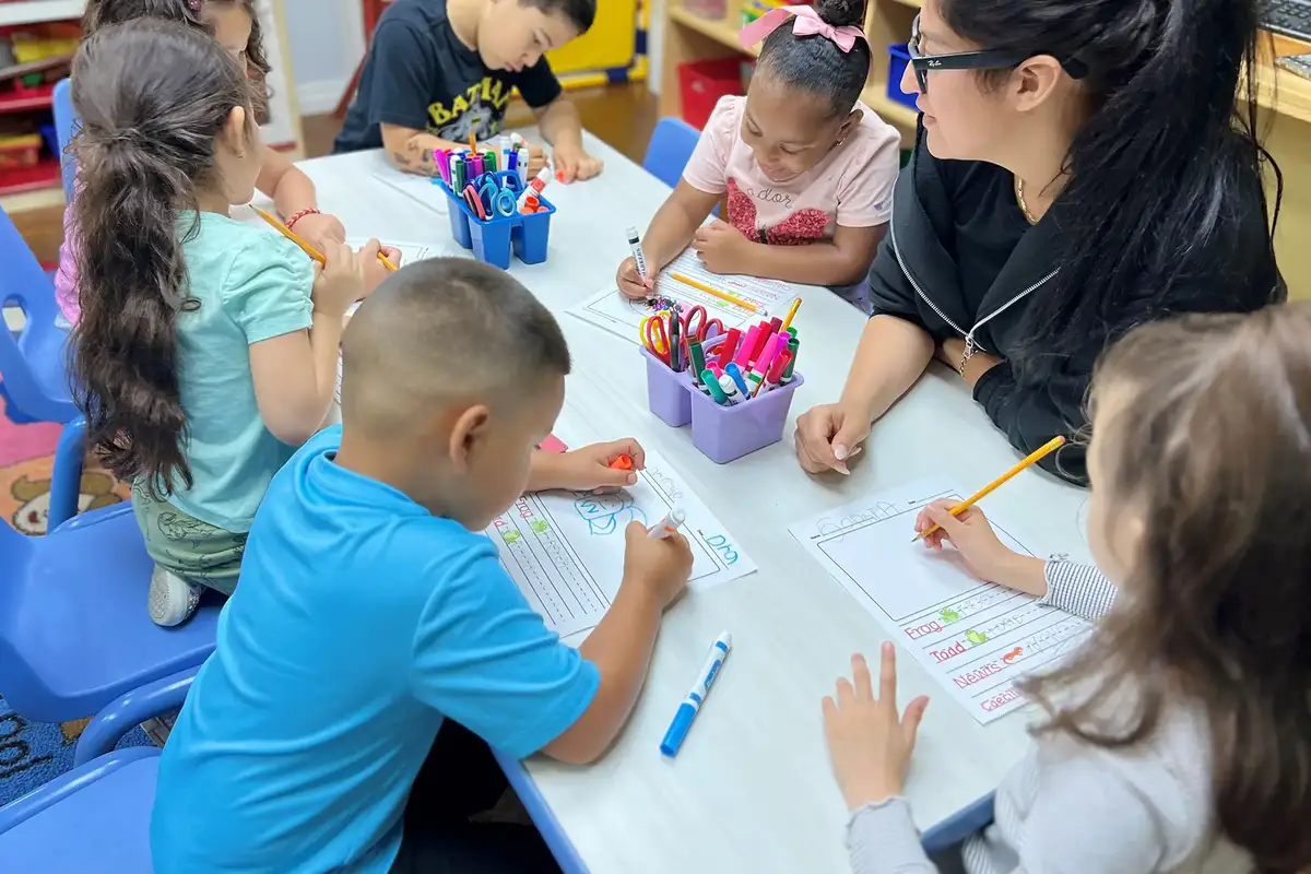 Children in Sierra Preschool's Spanish-English dual language immersion program learning with a bilingual teacher
