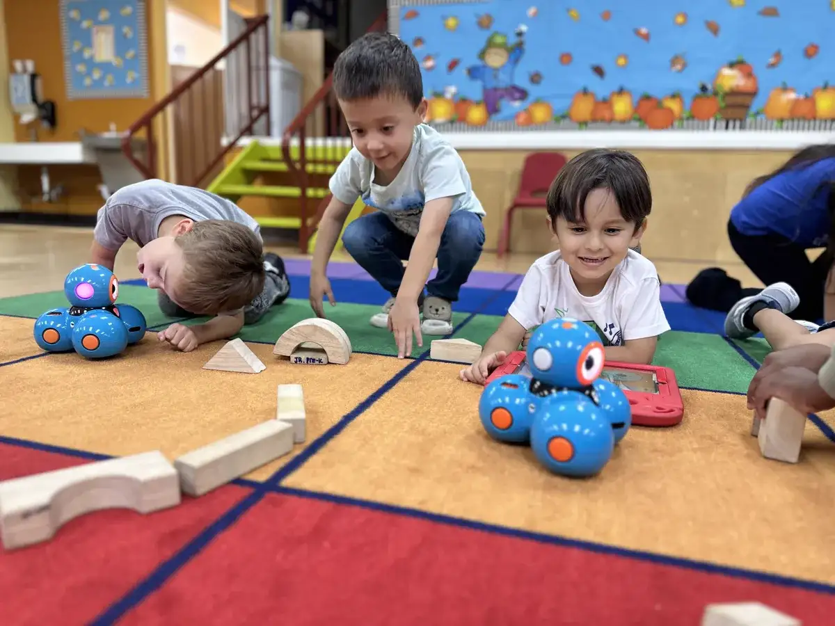 Children engaged in hands-on STEAM learning activities at Sierra Preschool