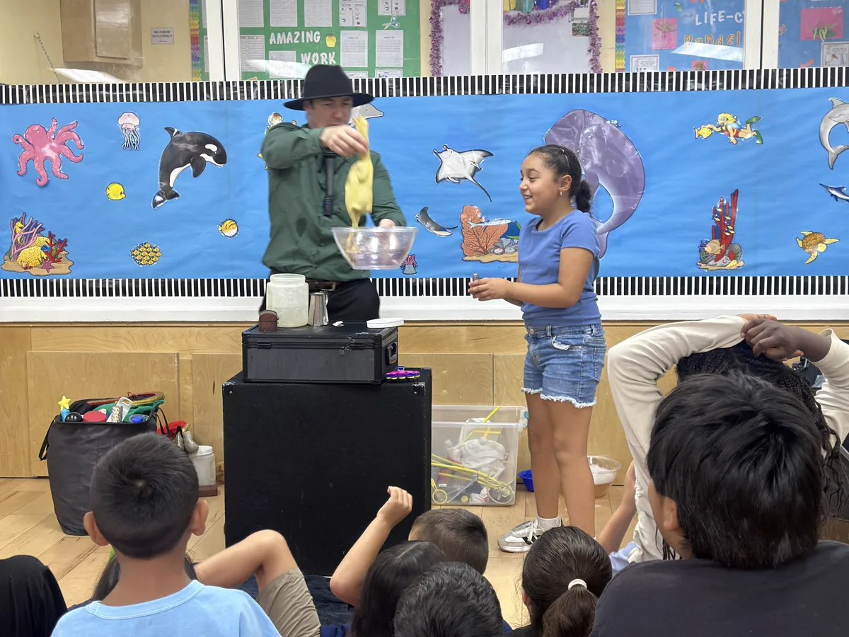 Children attending an interactive educational assembly with a special guest presenter at Sierra Preschool