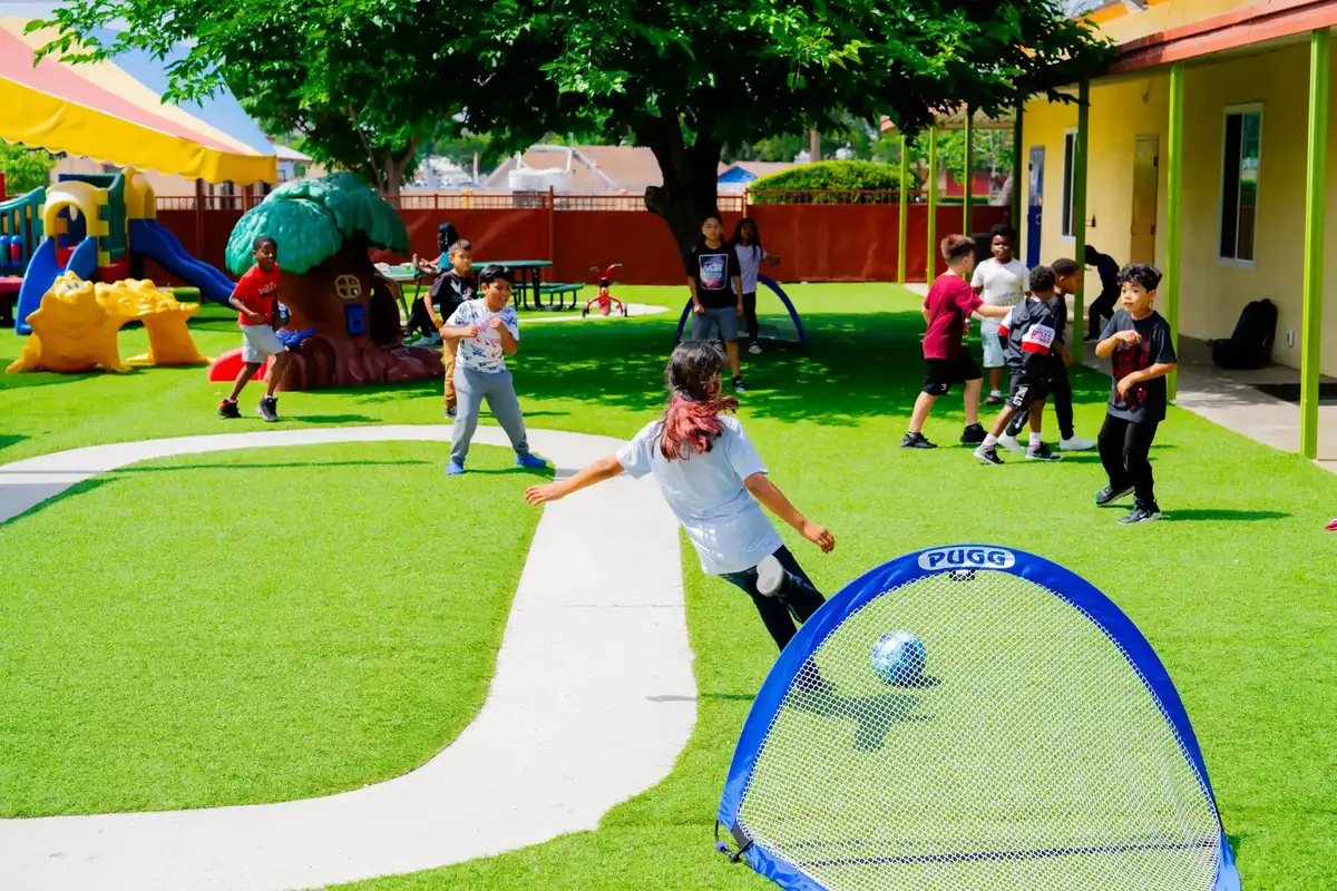 Children playing soccer as part of outdoor sports enrichment at Sierra Preschool building teamwork and leadership