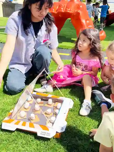 Children enjoying outdoor summer activities, learning, and creative play in a preschool outdoor learning center